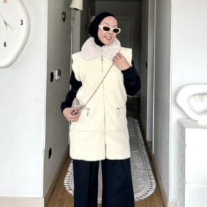 Krem kürk yakalı fermuarlı uzun yelek, lacivert kombinle yakın çekim